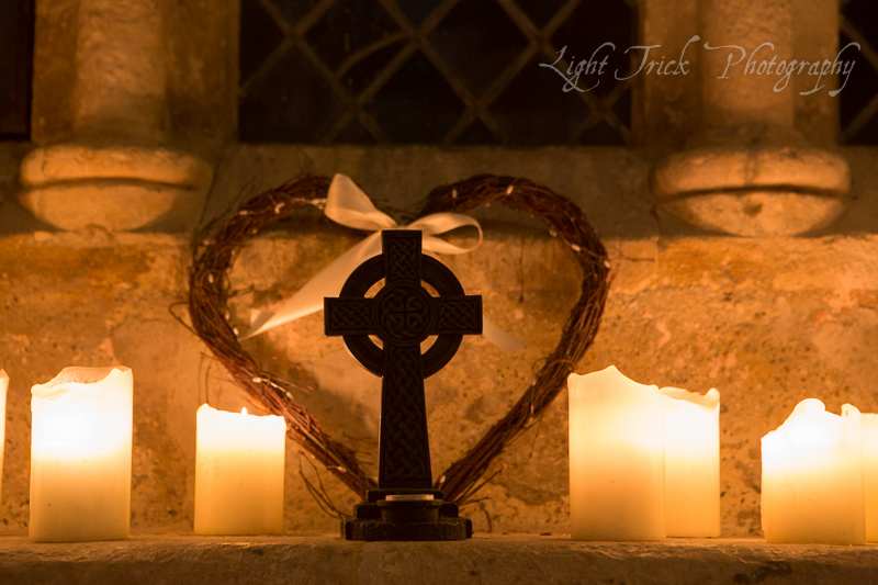 cross with candles in a chapel